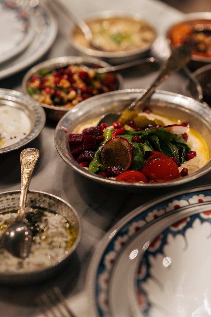 A vibrant array of Mediterranean meze served with fresh vegetables and hummus, perfect for a flavorful dining experience.
