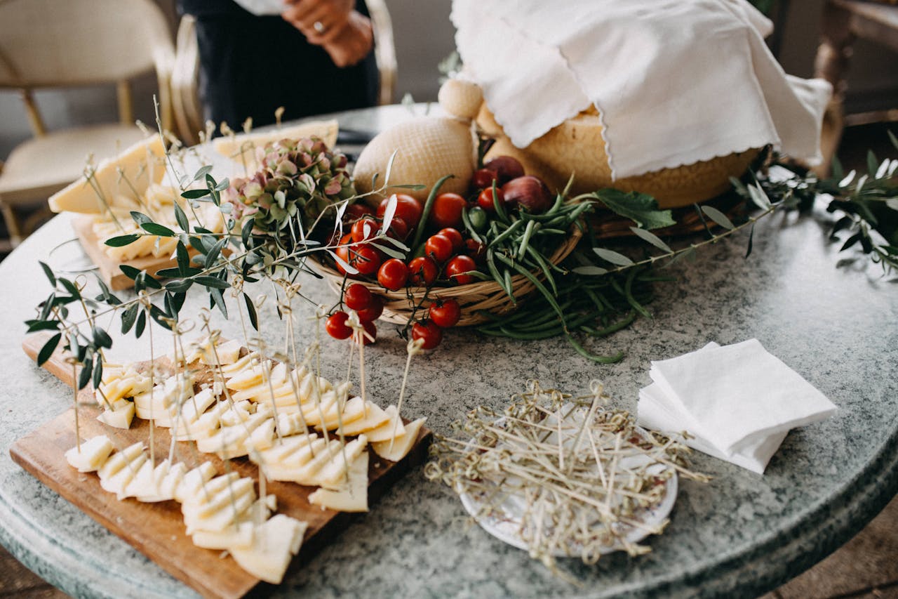 heros-img Serving of sliced cheese and cherry tomatoes on a marble table with fresh herbs.